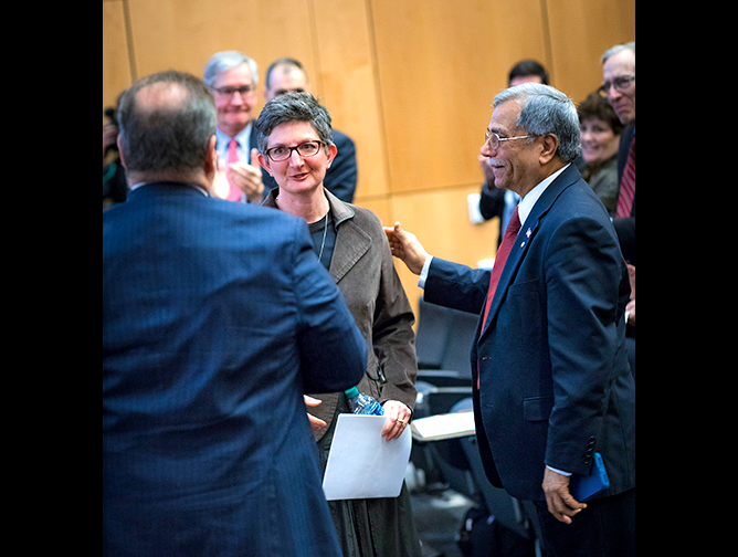 Rabbi Francine Roston is greeted by Paul Goldenberg and Mohammad Ali Chaudry 